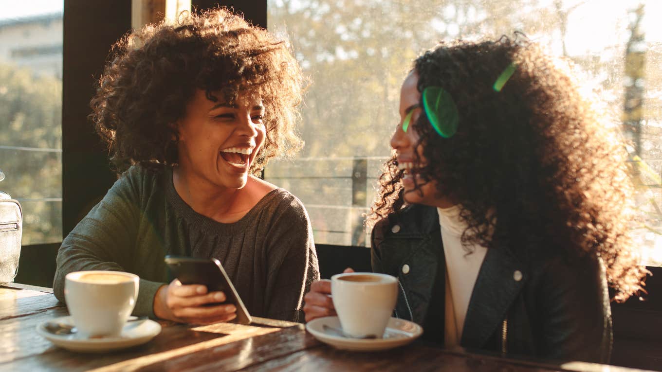 Two friends having coffee and talking. 