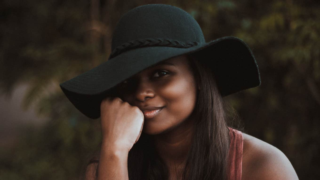 Single Woman Launches A GoFundMe To Pay For A Matchmaker Woman smirking in sun hat