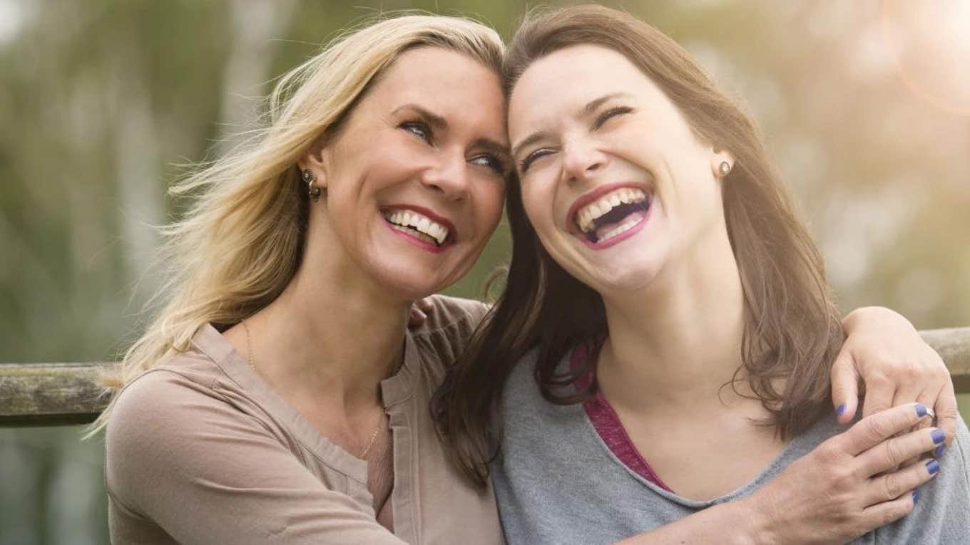 two sisters hugging and laughing