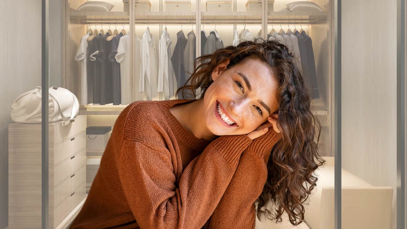 Woman smiling in front of her organized closet