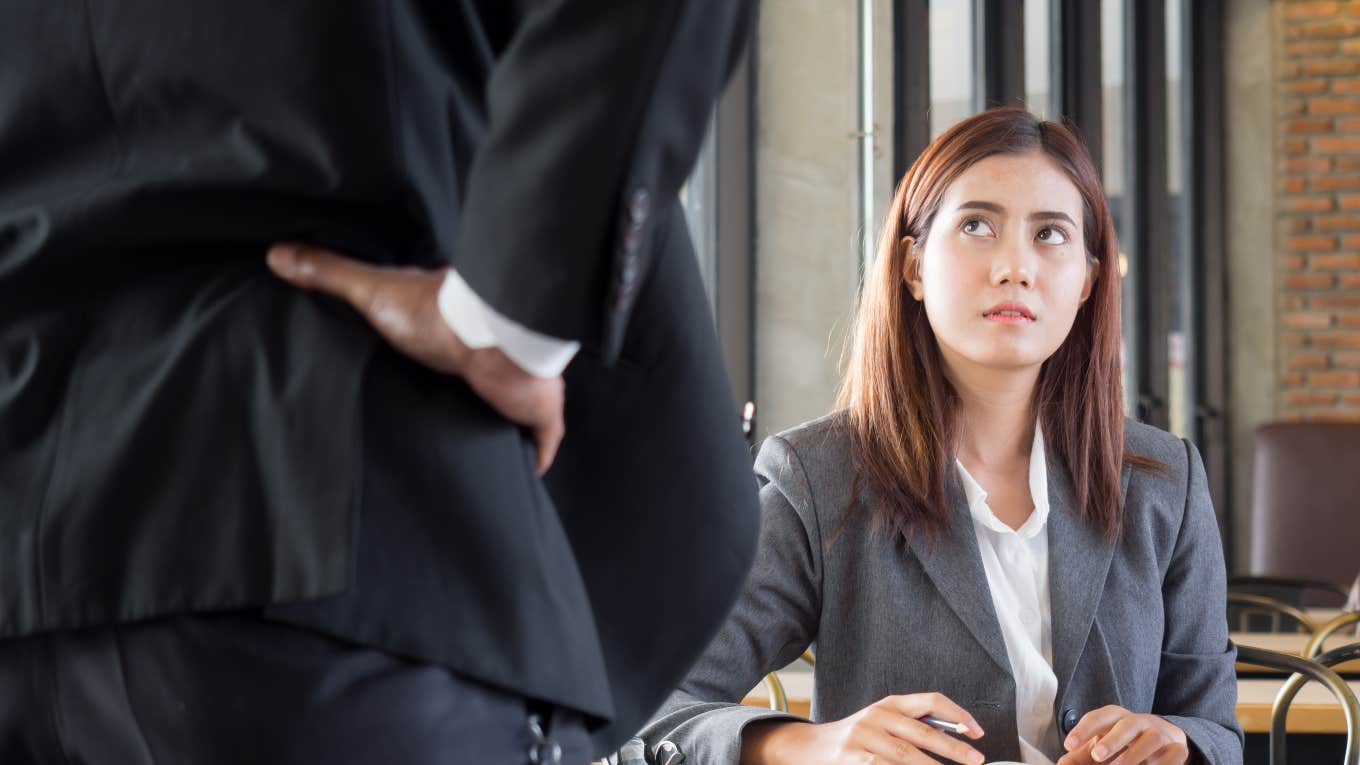 employee with intimidating boss standing over her