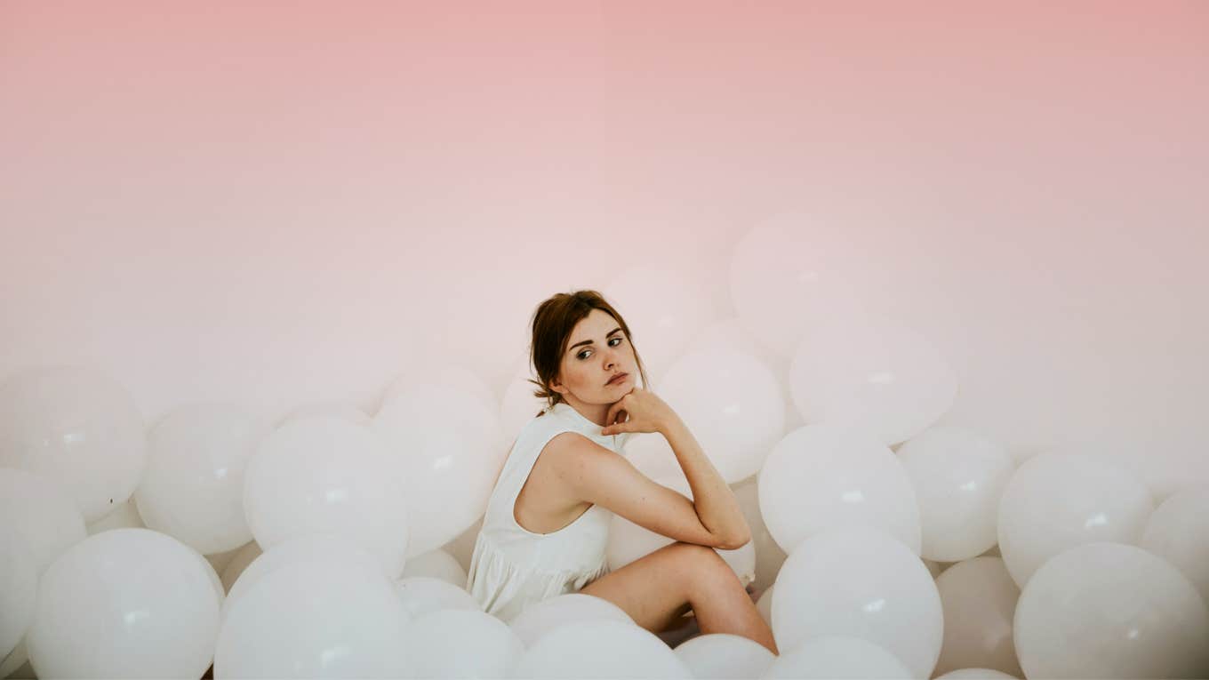 Woman surrounded by balloons, barrier 