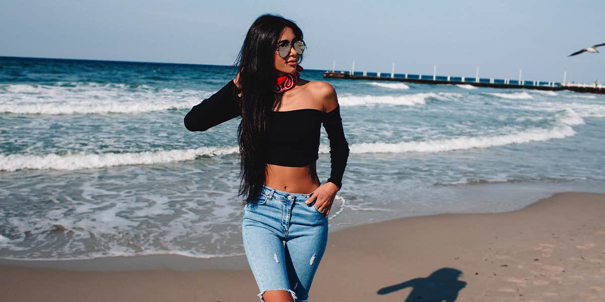 woman posing by the ocean