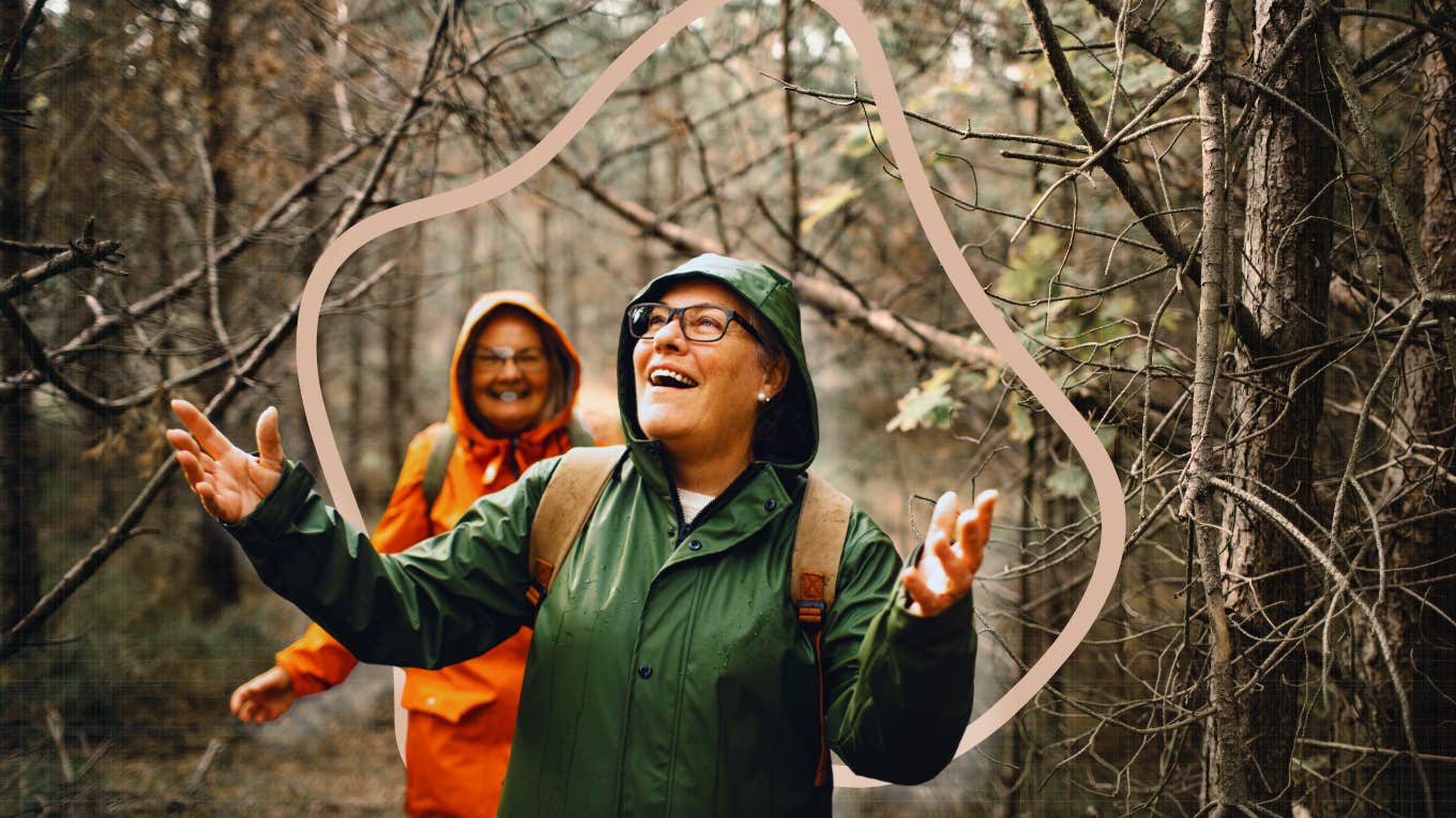 Woman hiking in nature, as it rains, embracing the weather