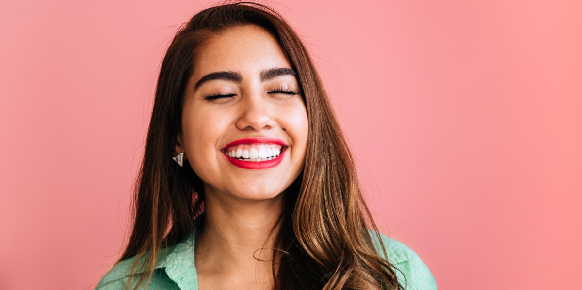 Without meaning smiling showing teeth