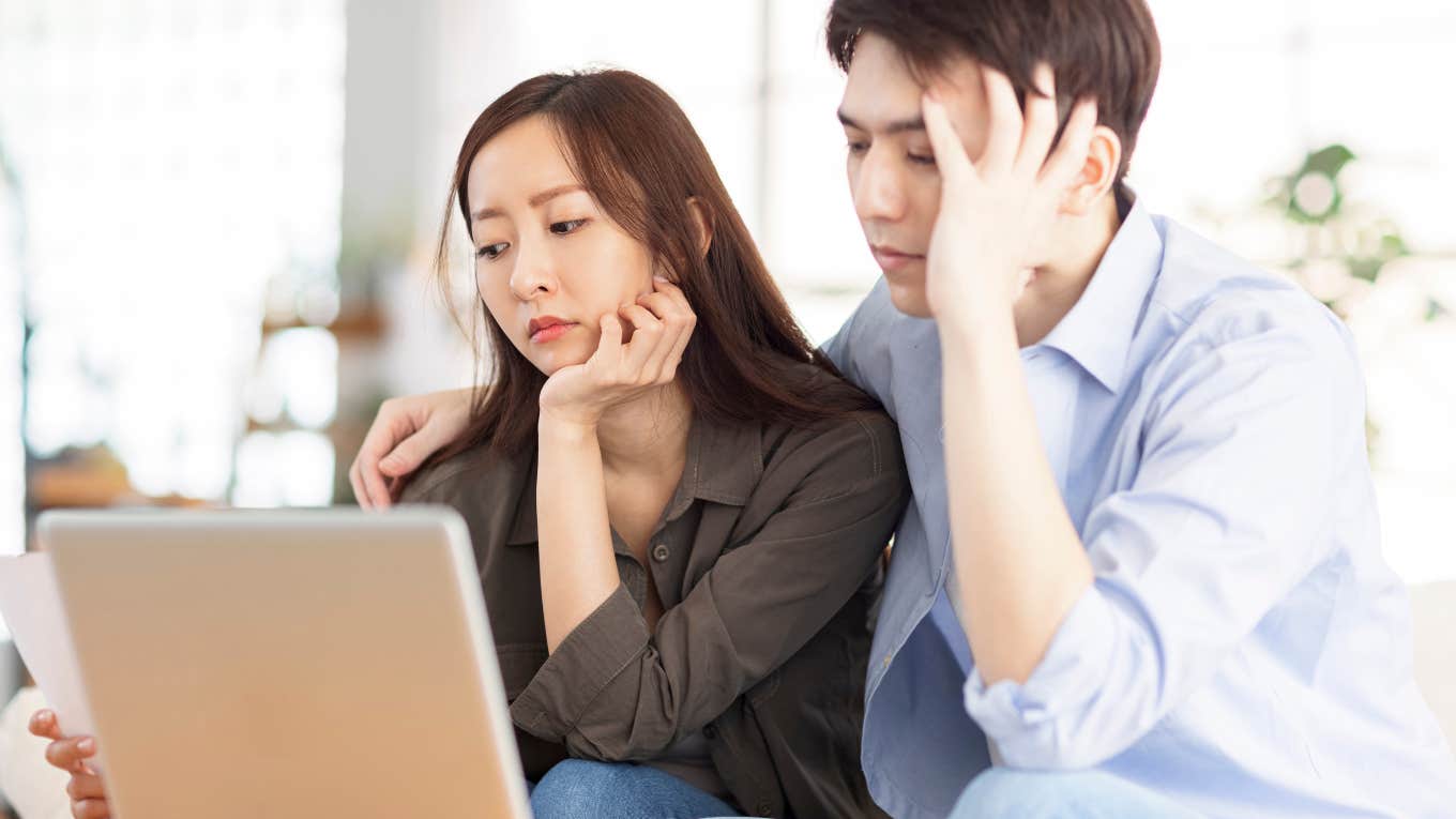 Upset couple using laptop 