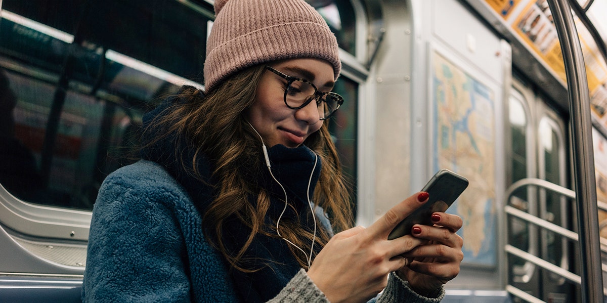 waoman texting on subway