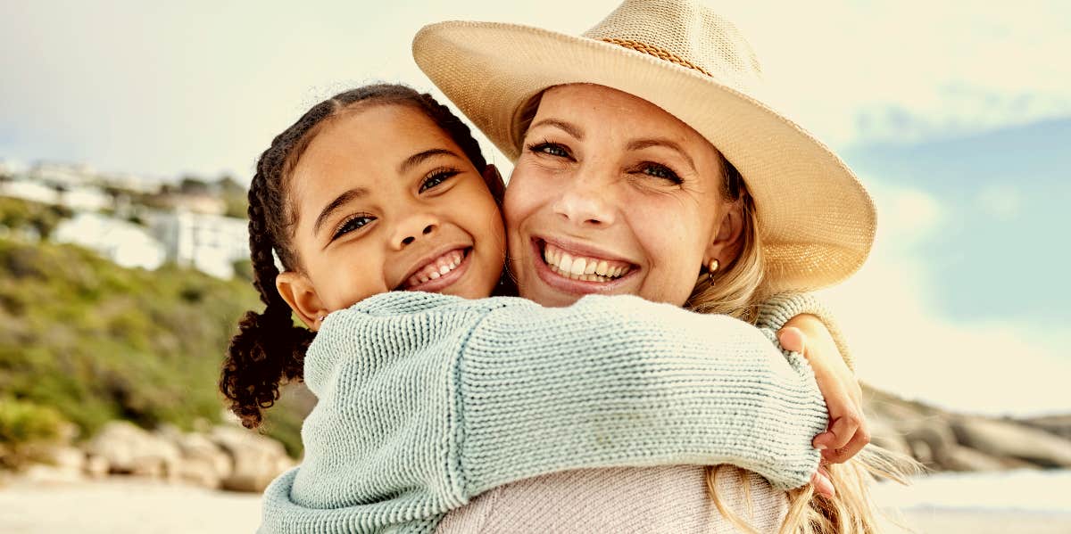 Happy mom and daughter at the beach