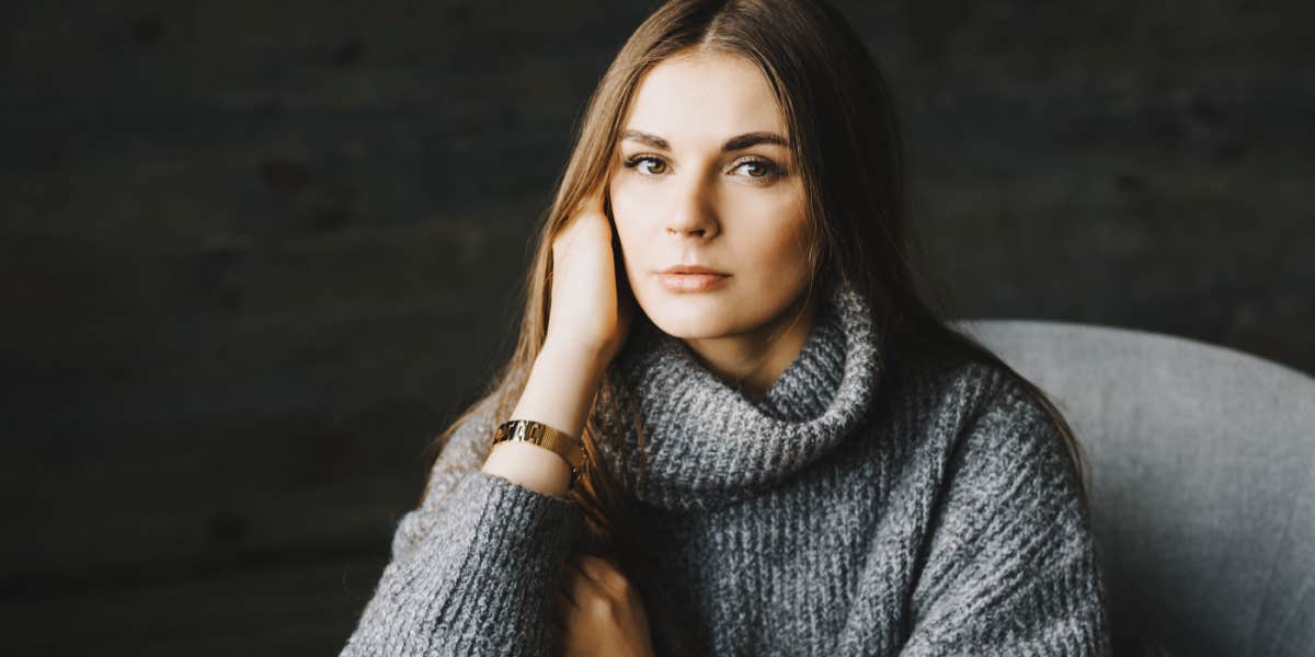 serious woman sitting in a chair, alone