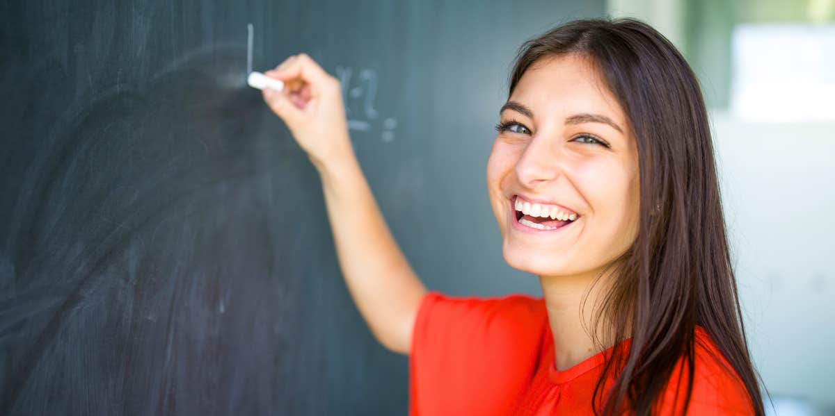 woman using the soulmate math trick on a chalkboard