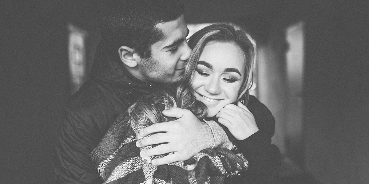 black and white photo of man and woman embracing