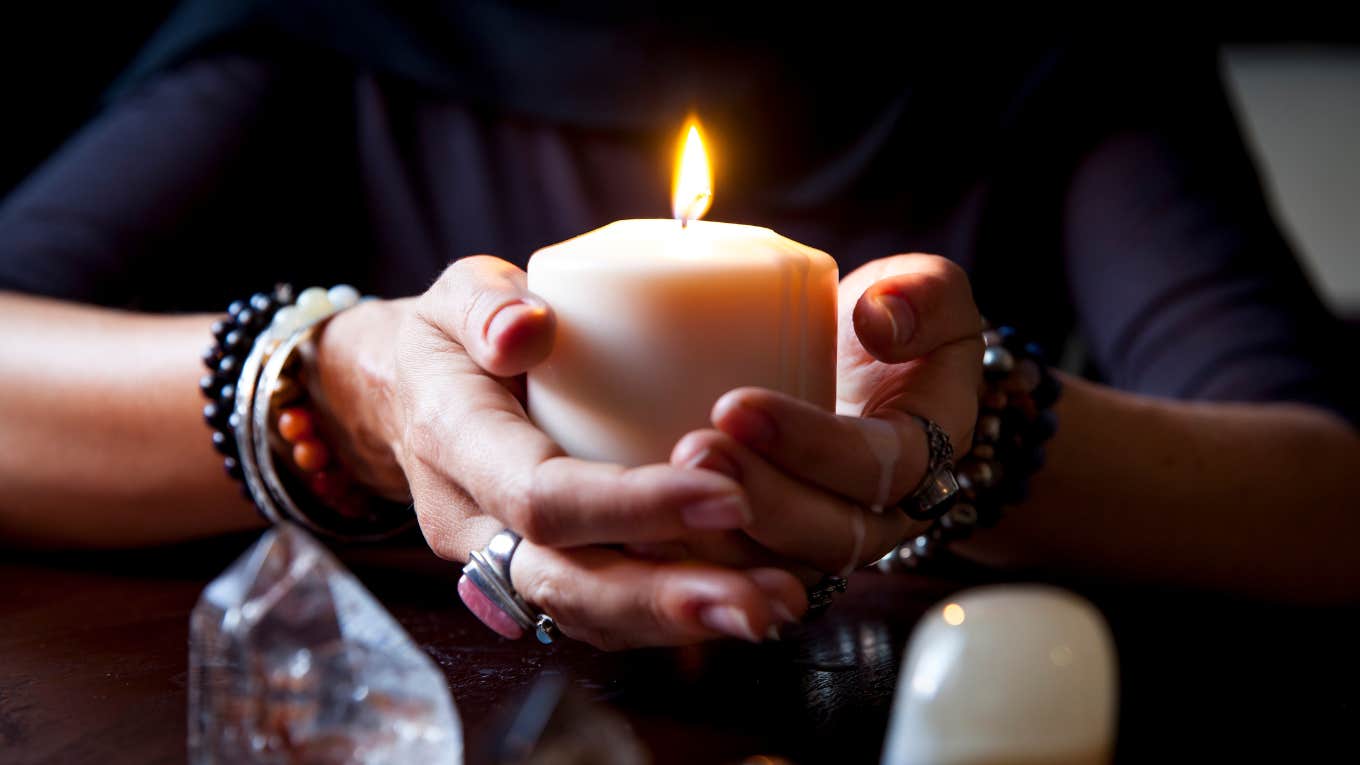 hands holding a candle