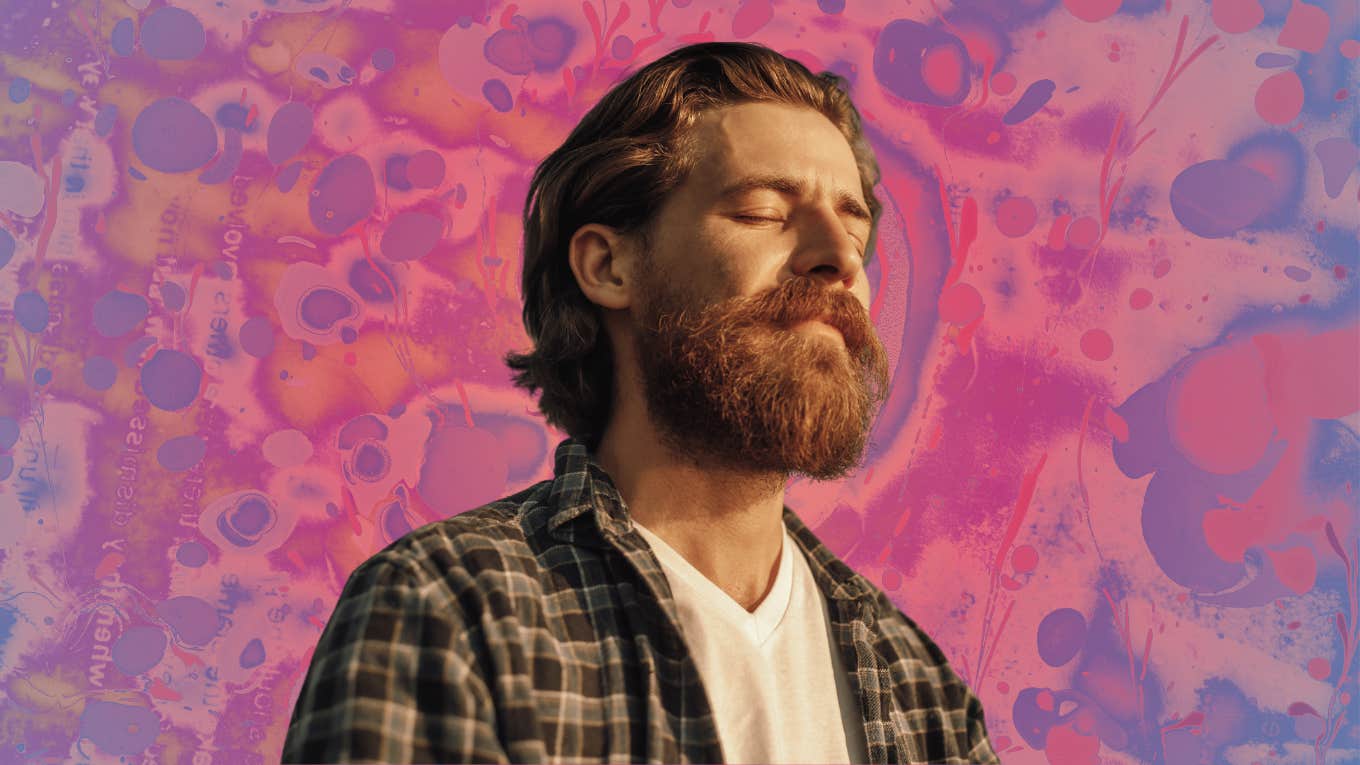 The 10 Stages Of Spiritual Awakening That Offer You Clarity, Direction And Sense Of Purpose Man meditating in front of a pink background.