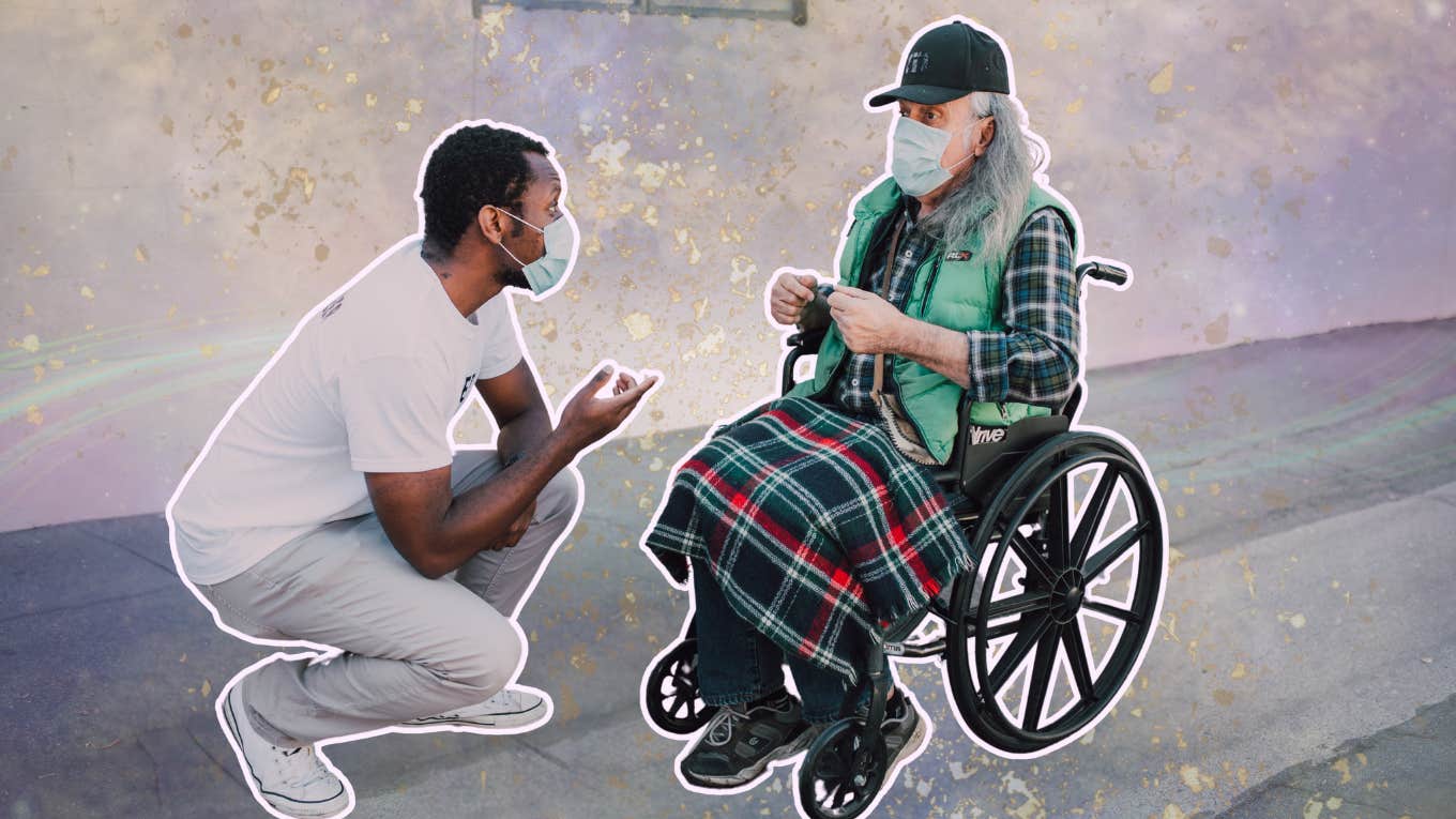 Man showing kindness to person in wheelchair 