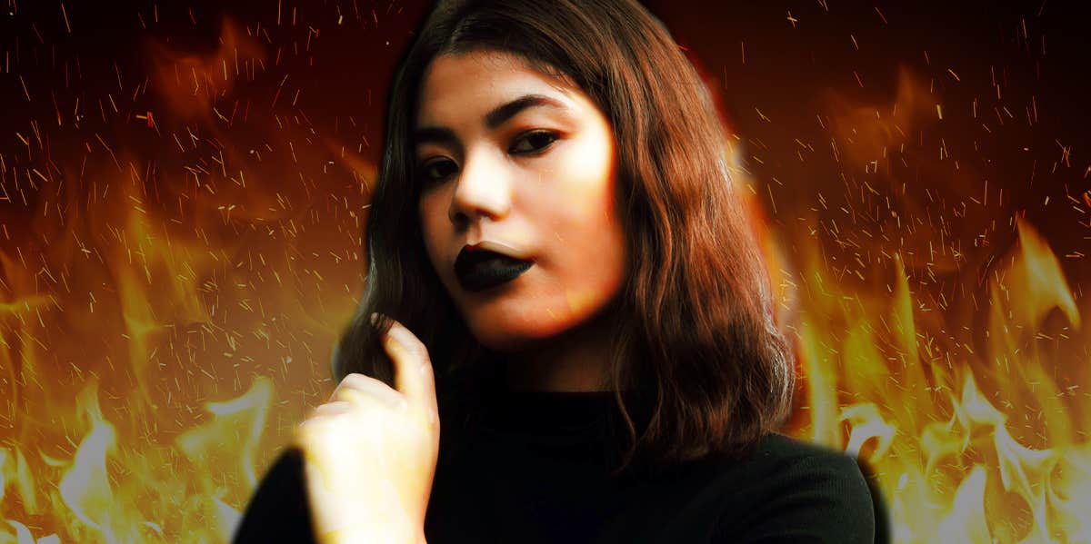 18 Common Dreams About Fire And What They All Mean woman with flames behind her