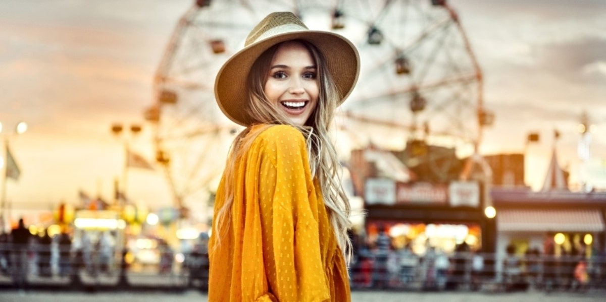Angel Number 555 Meaning — Why You Keep Seeing 555 girl smiling in front of ferris wheel