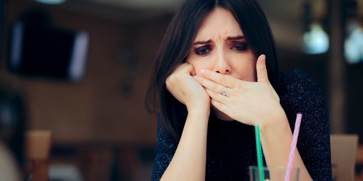 woman covering mouth