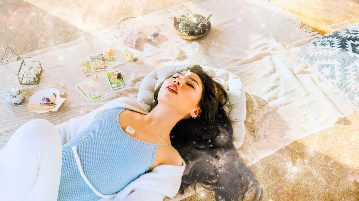 The Morning Spiritual Ritual To Make Each Day So Much Better woman balancing her chakras with crystals in early morning sun