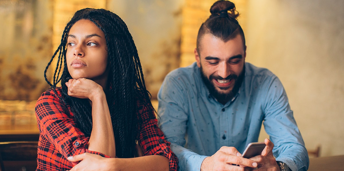 woman looking away with head in hands from man