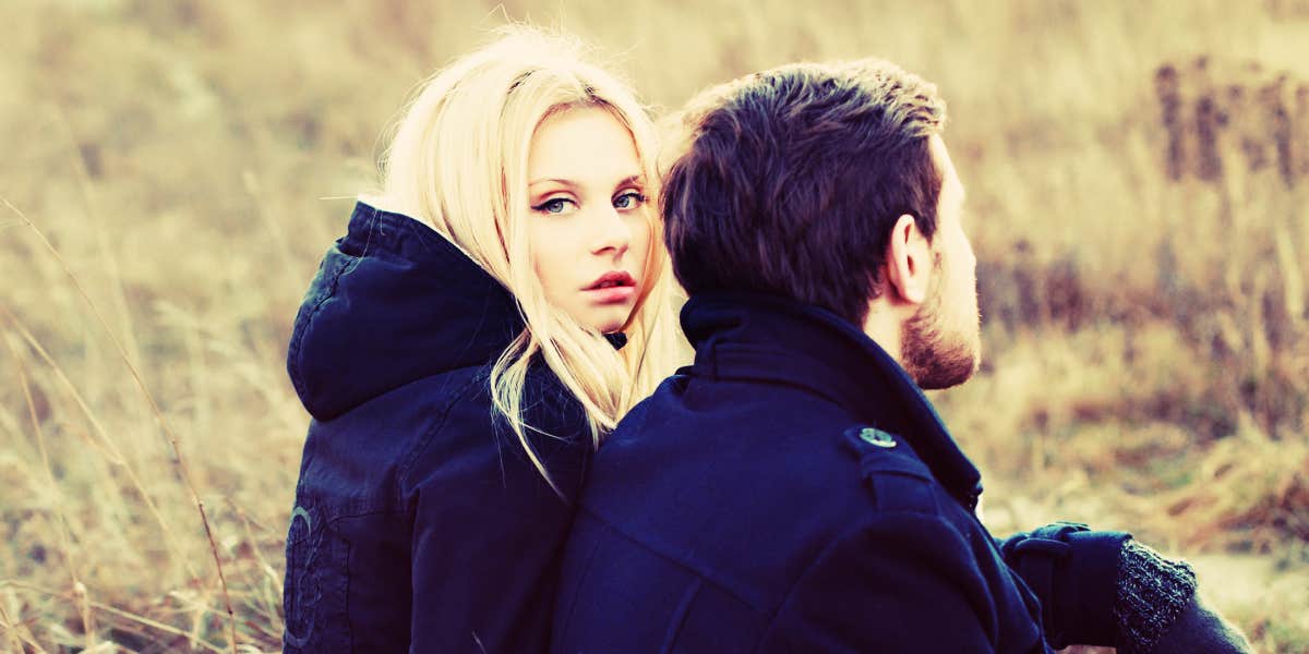 Save a marriage when spouse wants to leave couple in a field, blonde woman looks right at camera while man looks away