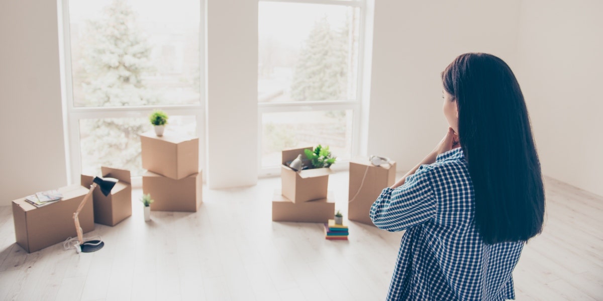 spring cleaning and mental health woman looking at boxes of things