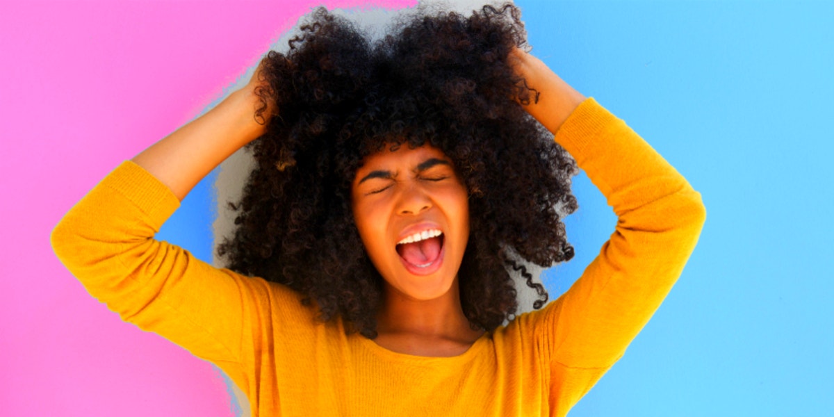 woman holding hair and screaming