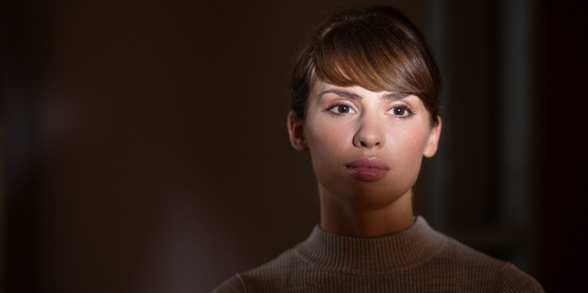starlighting woman in darkness with light on her face