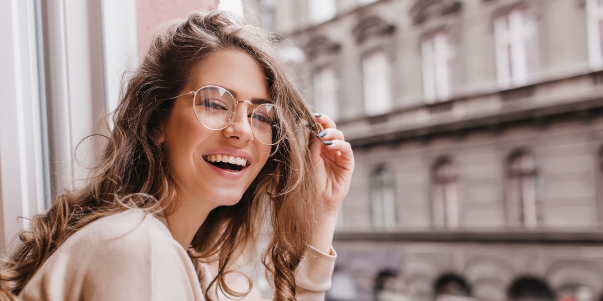 happy woman looking out a window