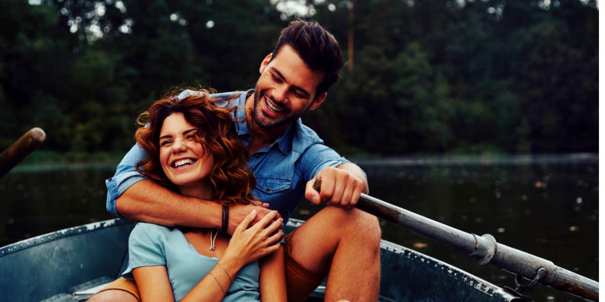 happy couple smiling in a boat