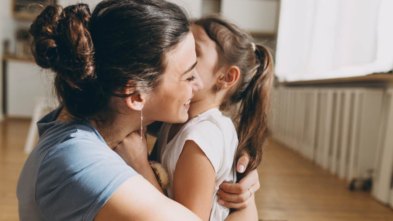 mom hugging daughter