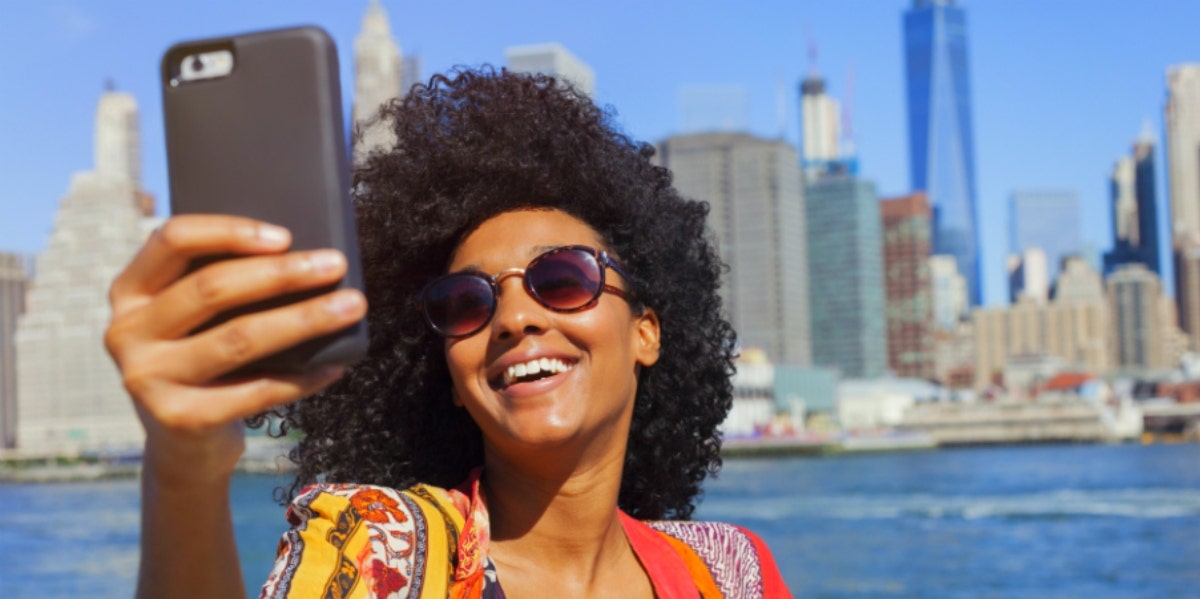 smiling woman with her phone on staycation