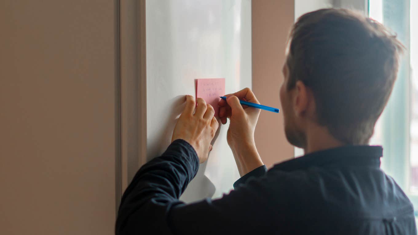 man leaving note on door