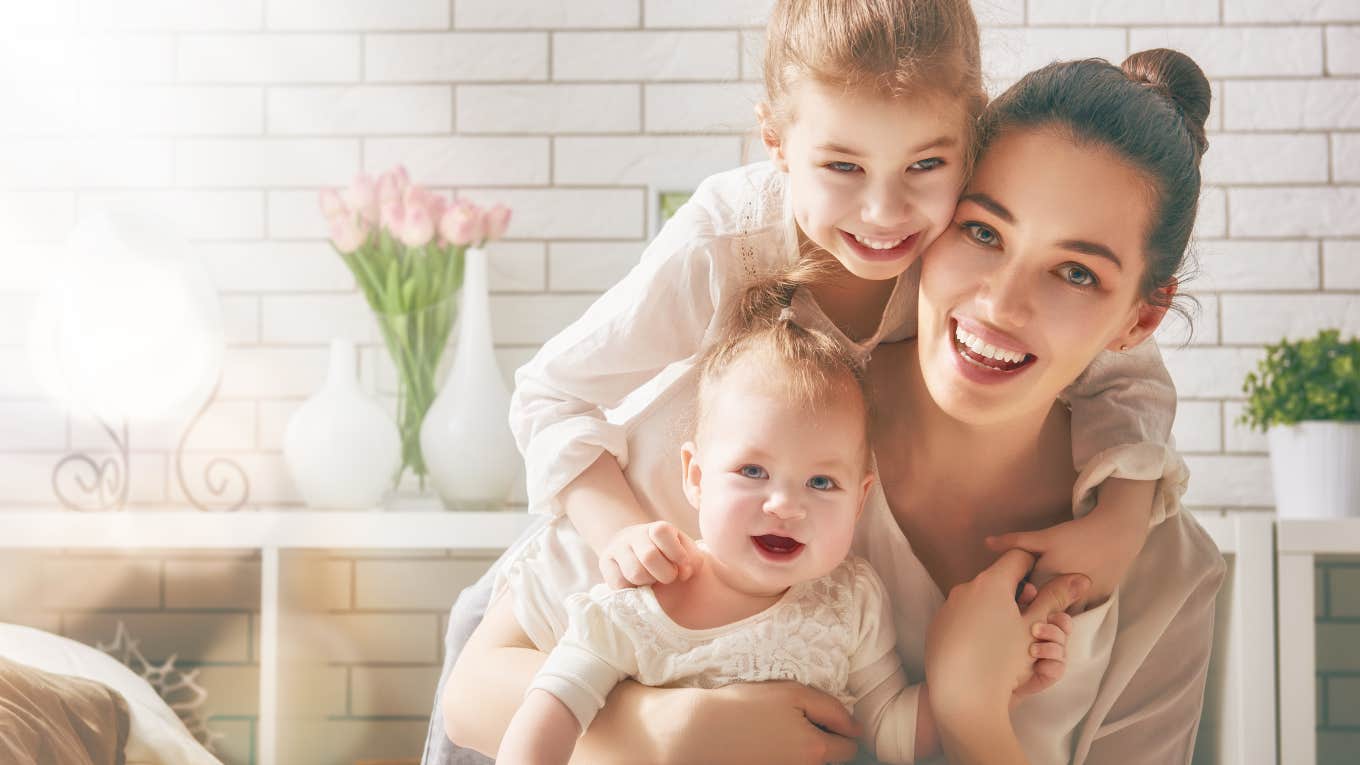 mom with toddler and baby cuddling