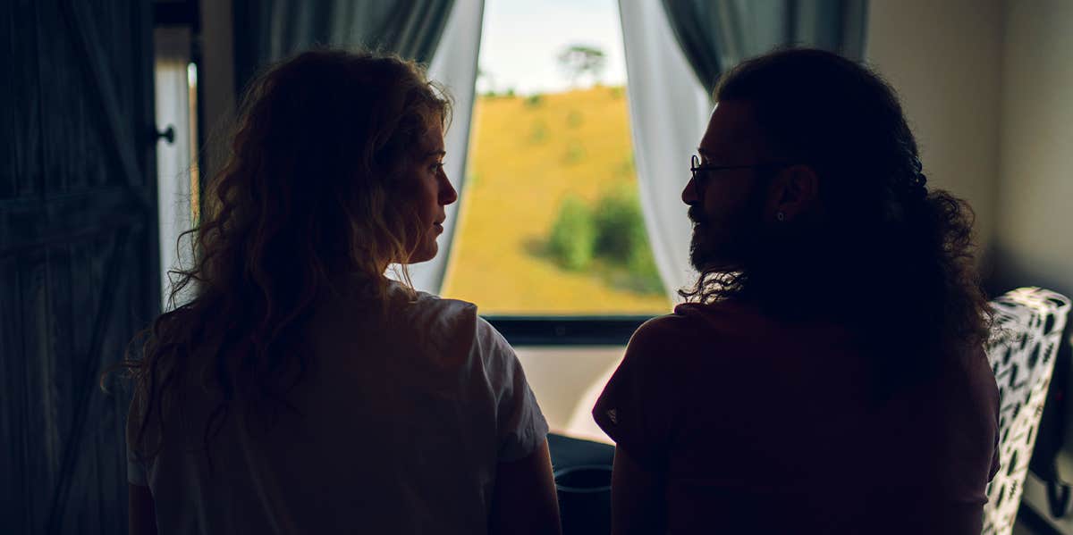 couple looking at each other in dark room