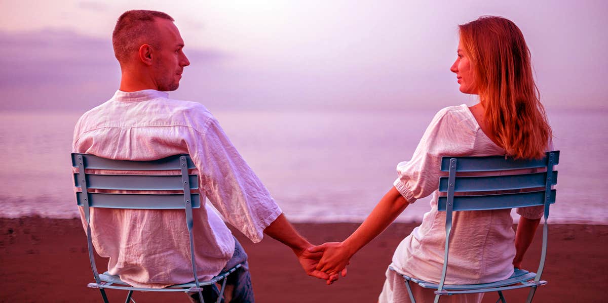 man and woman on the beach holding hands