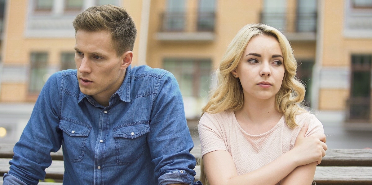 upset man and woman sitting outside