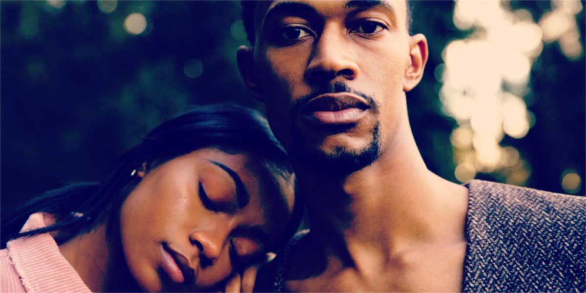 lovely Black couple outdoors, close-up, her head on his shoulder