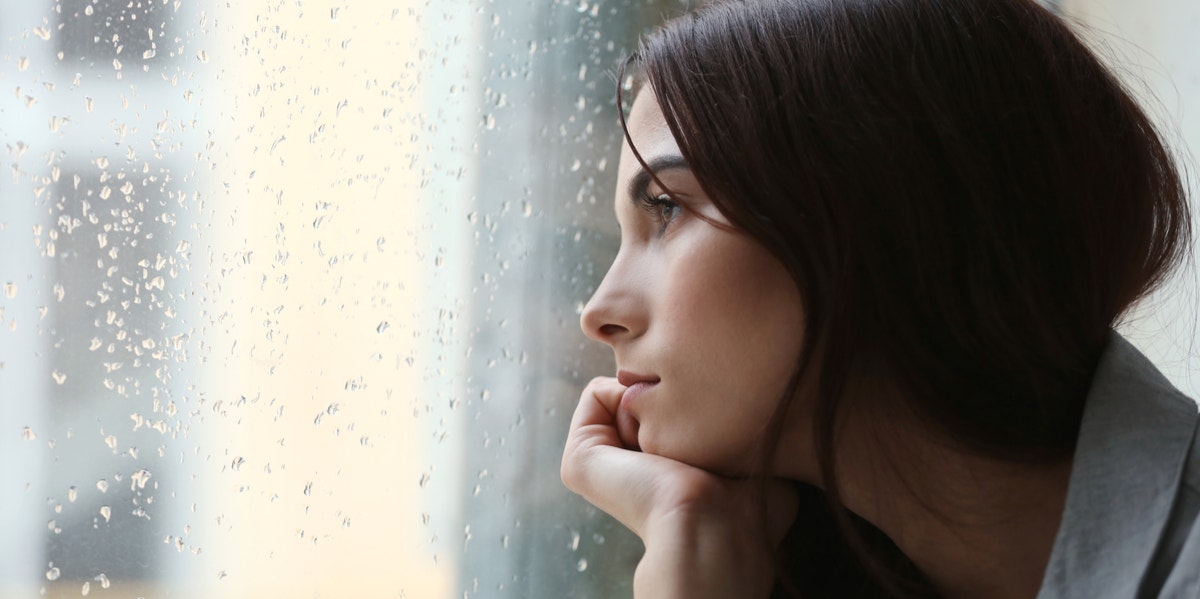 woman staring out the window