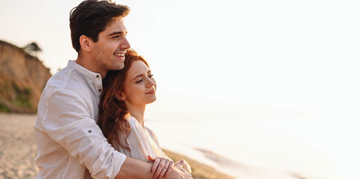Stop Measuring The Success Of Your Relationship By The Number Of Anniversaries couple cuddling on the beach