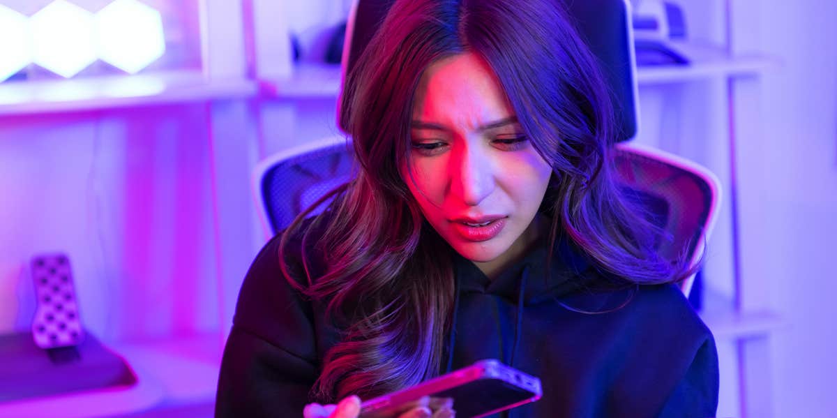 Why This Social Media Activity, More Than Any Other, Is Really, Really Bad For You woman looking at phone