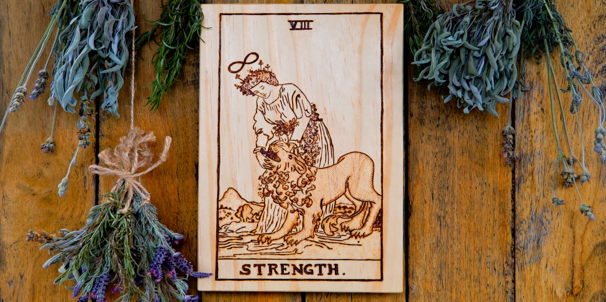 The Strength Tarot Card Meanings: Upright, Reversed & In Love Strength Tarot Card