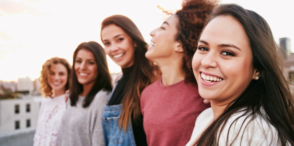 smiling group of five women