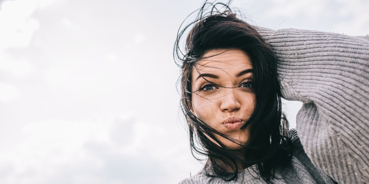 stuck mindset happy woman in gray sweater