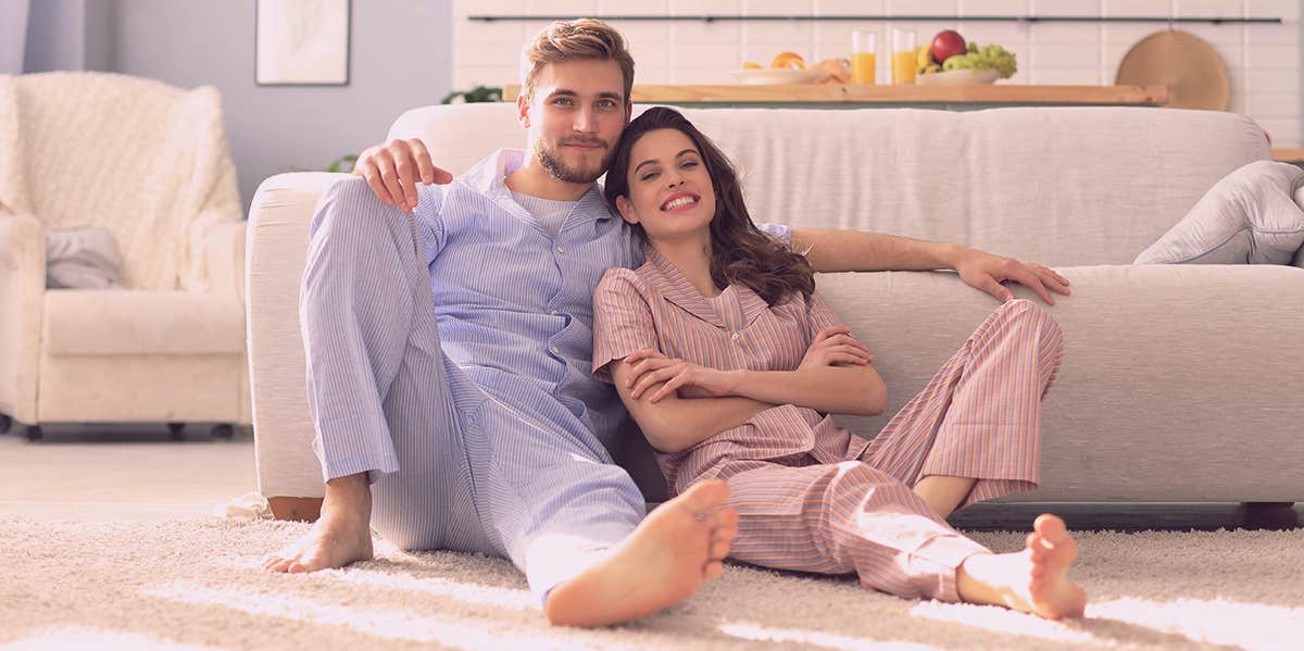 couple sitting by the couch in pajamas