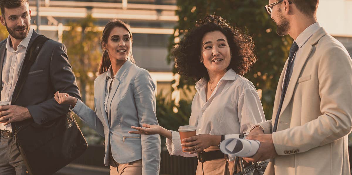 Study Says People With These Features Make Less Money people in suite walking