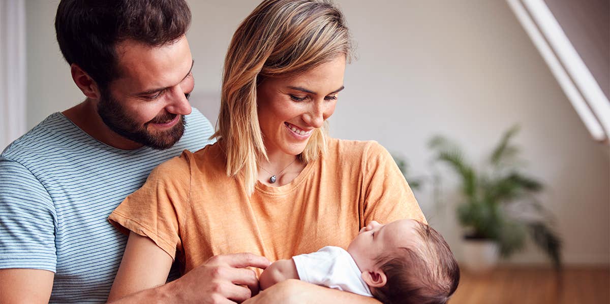 parents holding newborn baby