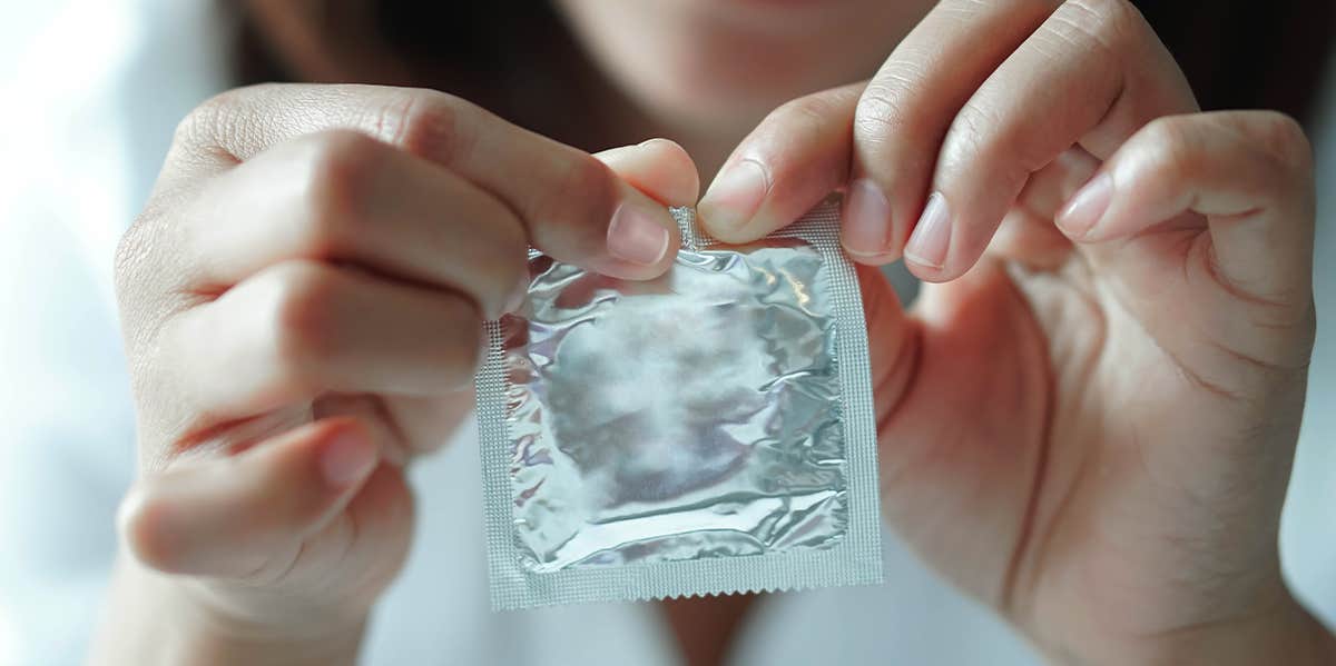 woman opening condom