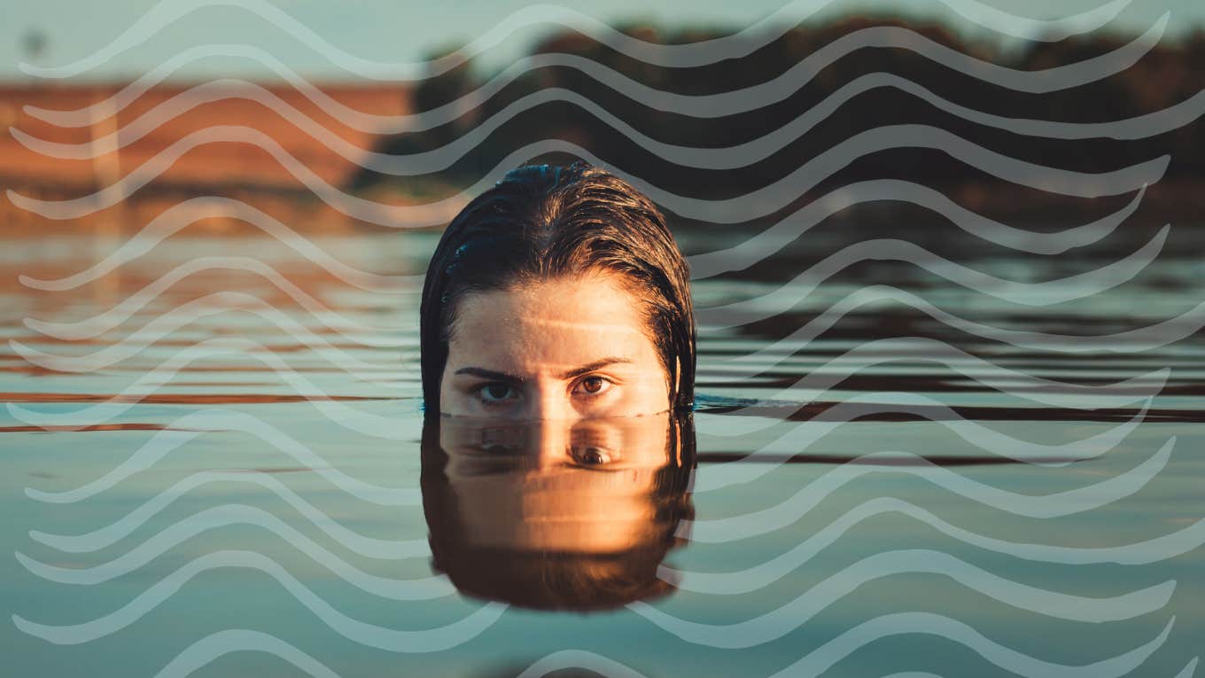 Woman with face half in and half out of water