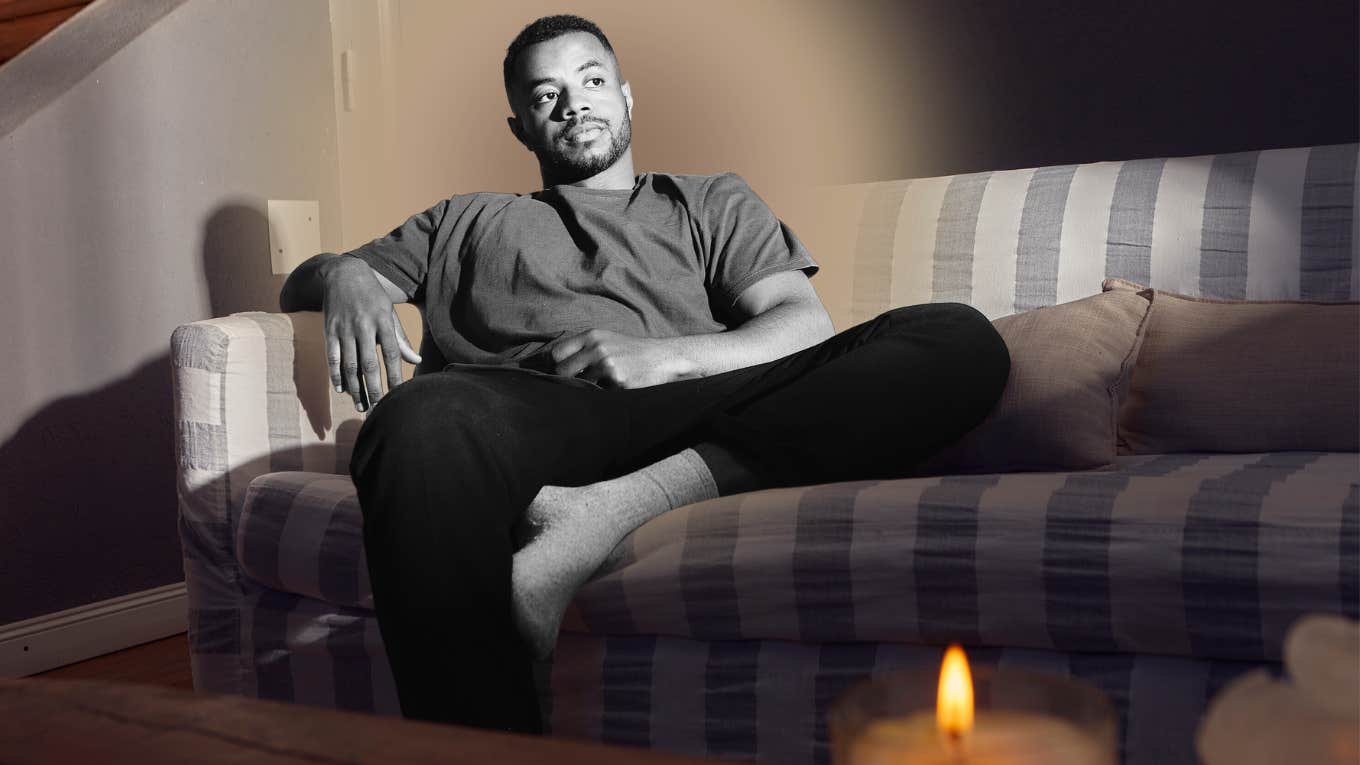 Depressed man disassociating on couch of his home