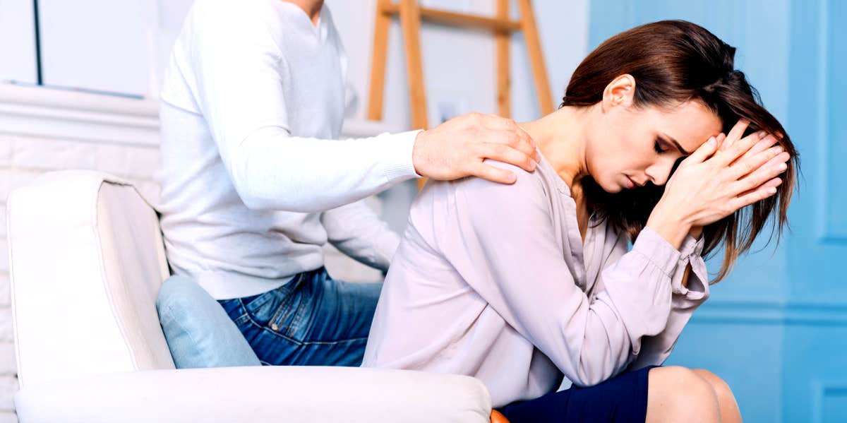 sad woman with man comforting her